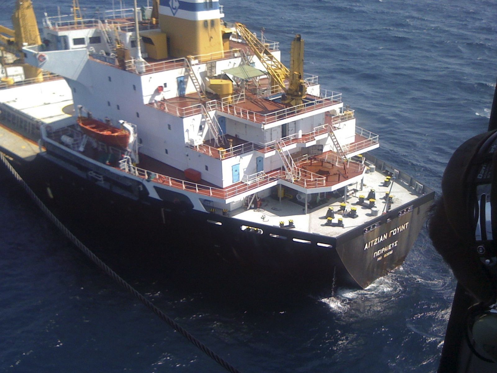 A member of Venezuela's Maritime Rescue and Aid service looks out of a helicopter during the rescue mission of the crew of the Greek bulk carrier Aegean Wind northeast of La Blanquilla