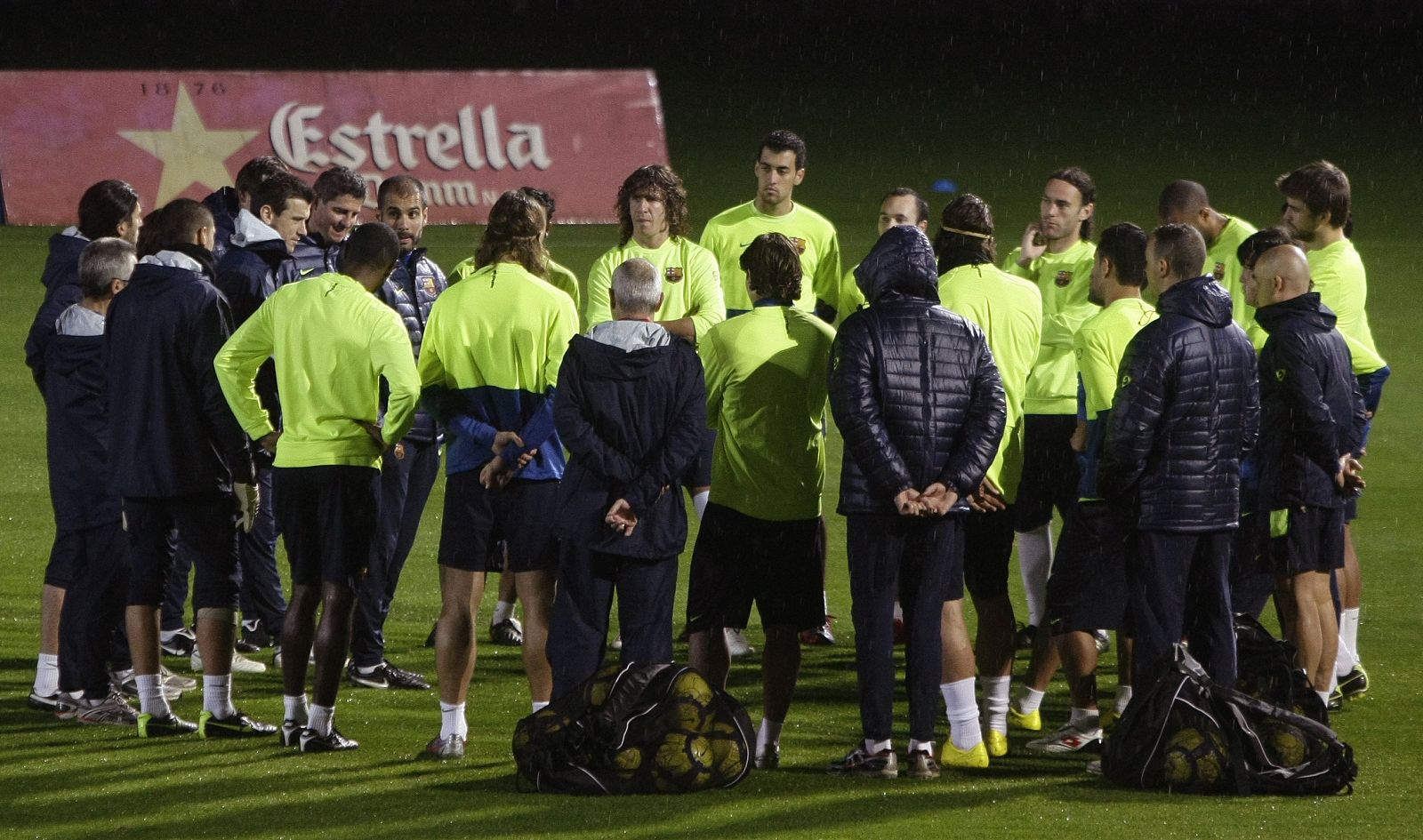 Barcelona's coach Pep Guardiola speaks to his players during a training session at Joan Gamper training Camp near Barcelona