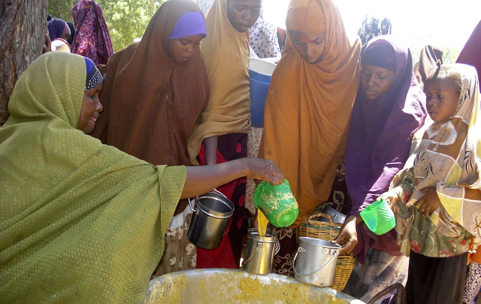 Somali women receive food distributed by the UN World Food Programme in Mogadishu