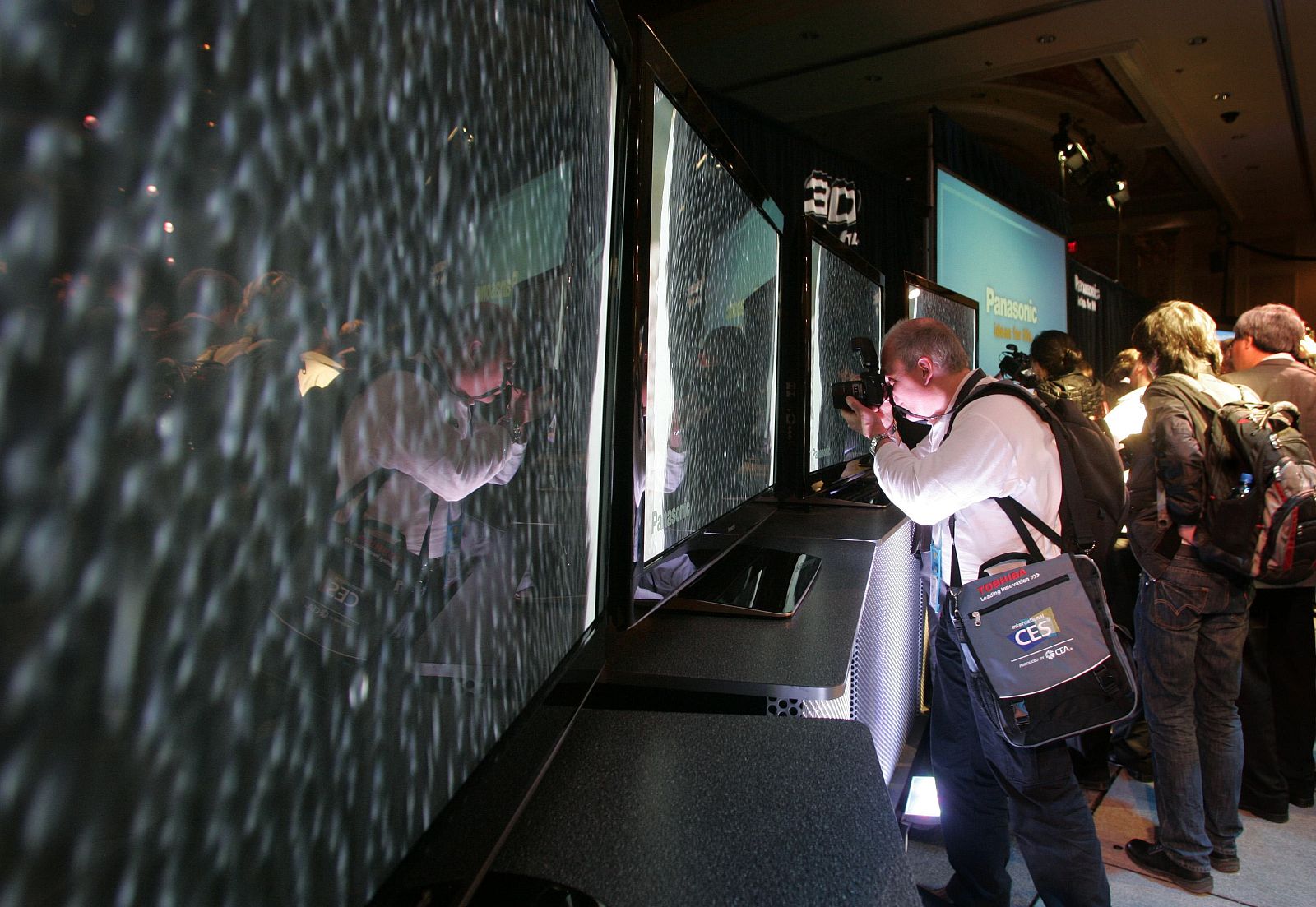 Photographer takes pictures of HD 3D capable plasma televisions during a news conference at the 2010 International Consumer Electronics Show (CES) in Las Vegas