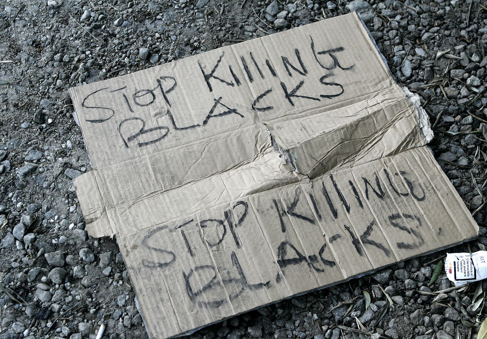 A banner lies on the ground at the end of a protest in the southern Italian town of Rosarno