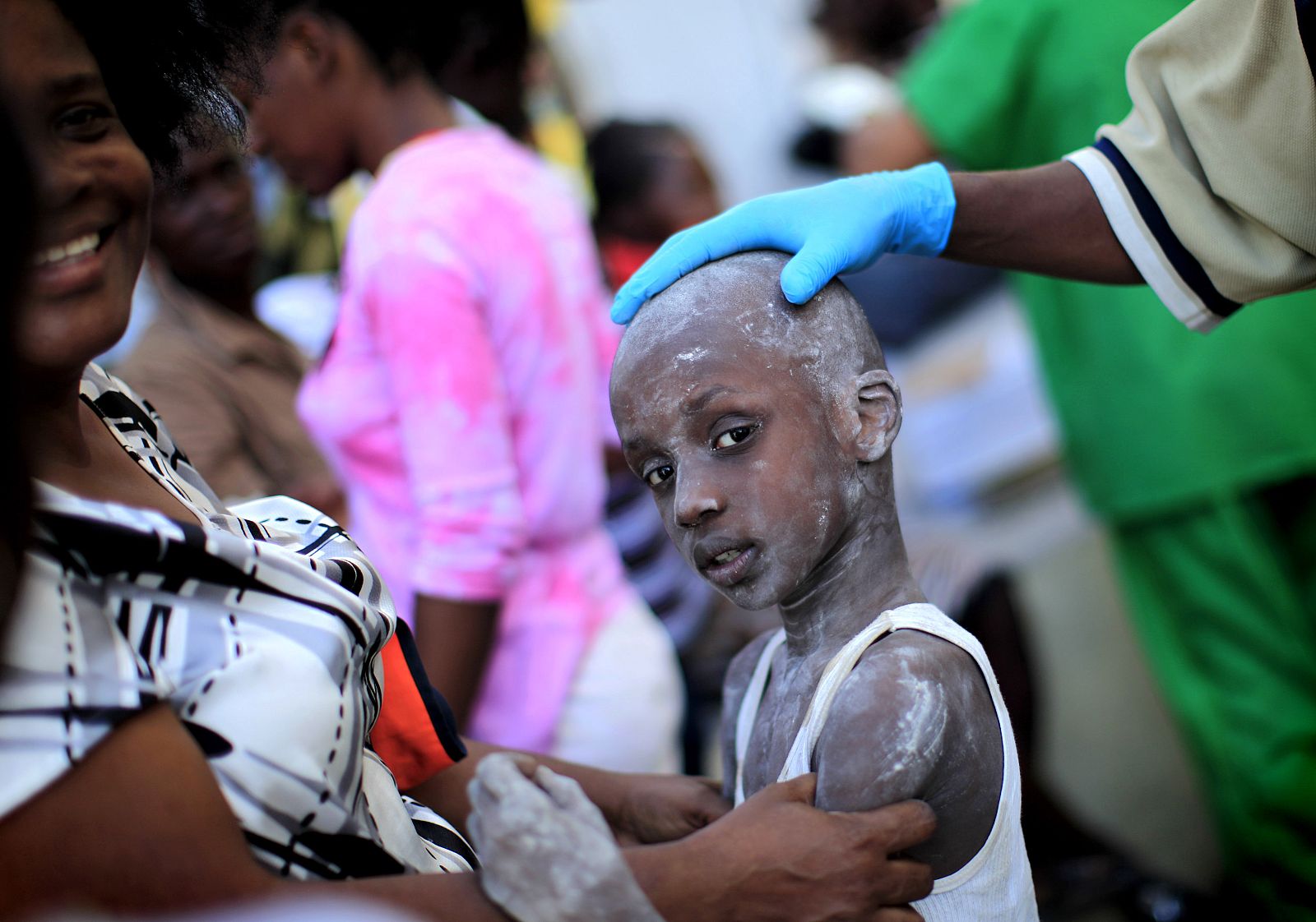 Doctors provides medical care to Samael Jachond, who was  rescued from the remains of his house, three days after a major earthquake hit Port-au-Prince
