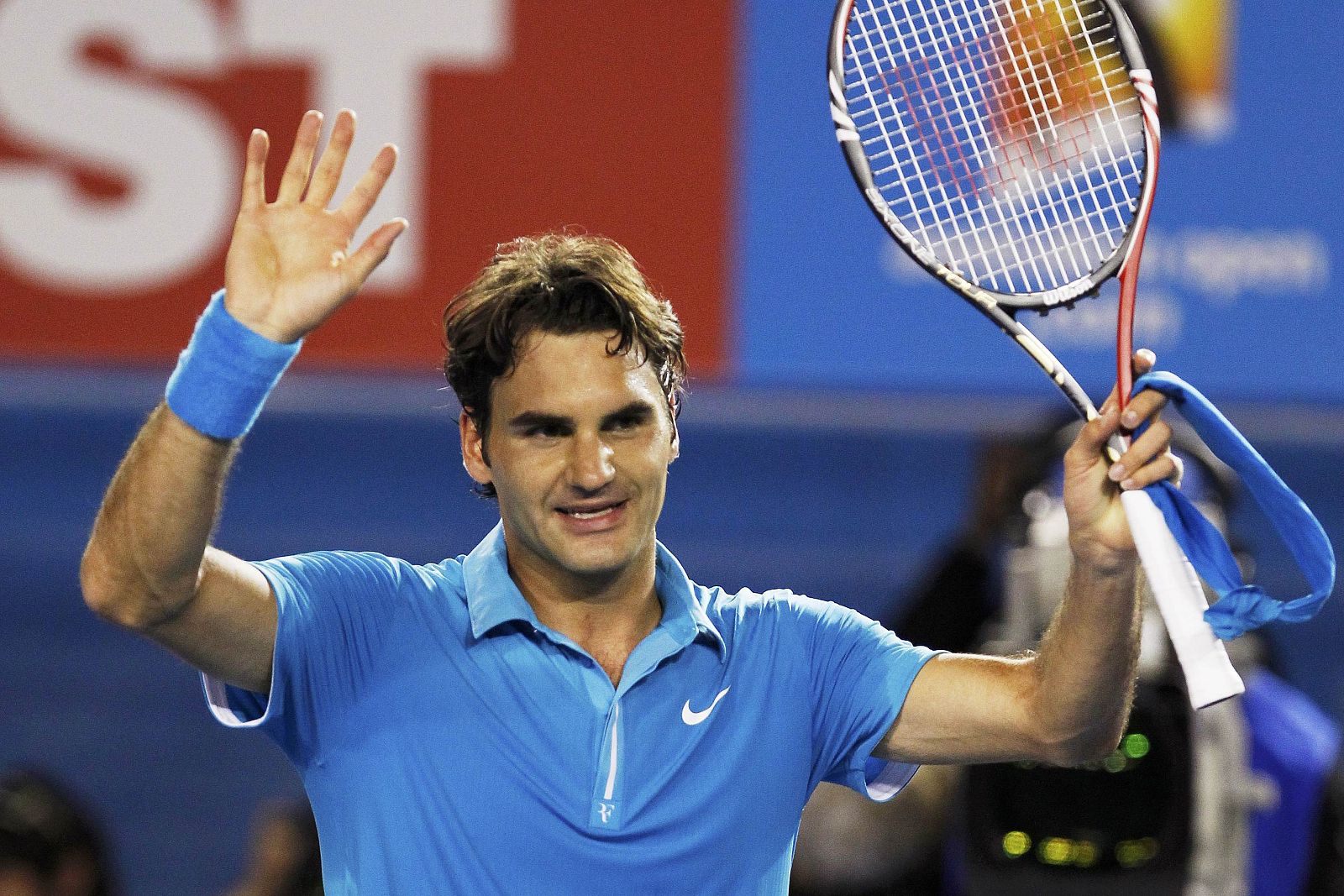 Roger Federer of Switzerland waves following his win over Australia's Lleyton Hewitt at the Australian Open tennis tournament in Melbourne