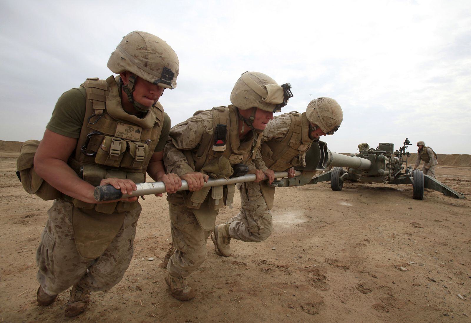 U.S. Marines exercise with an artillery piece in a U.S. Marines camp near town of Marjah