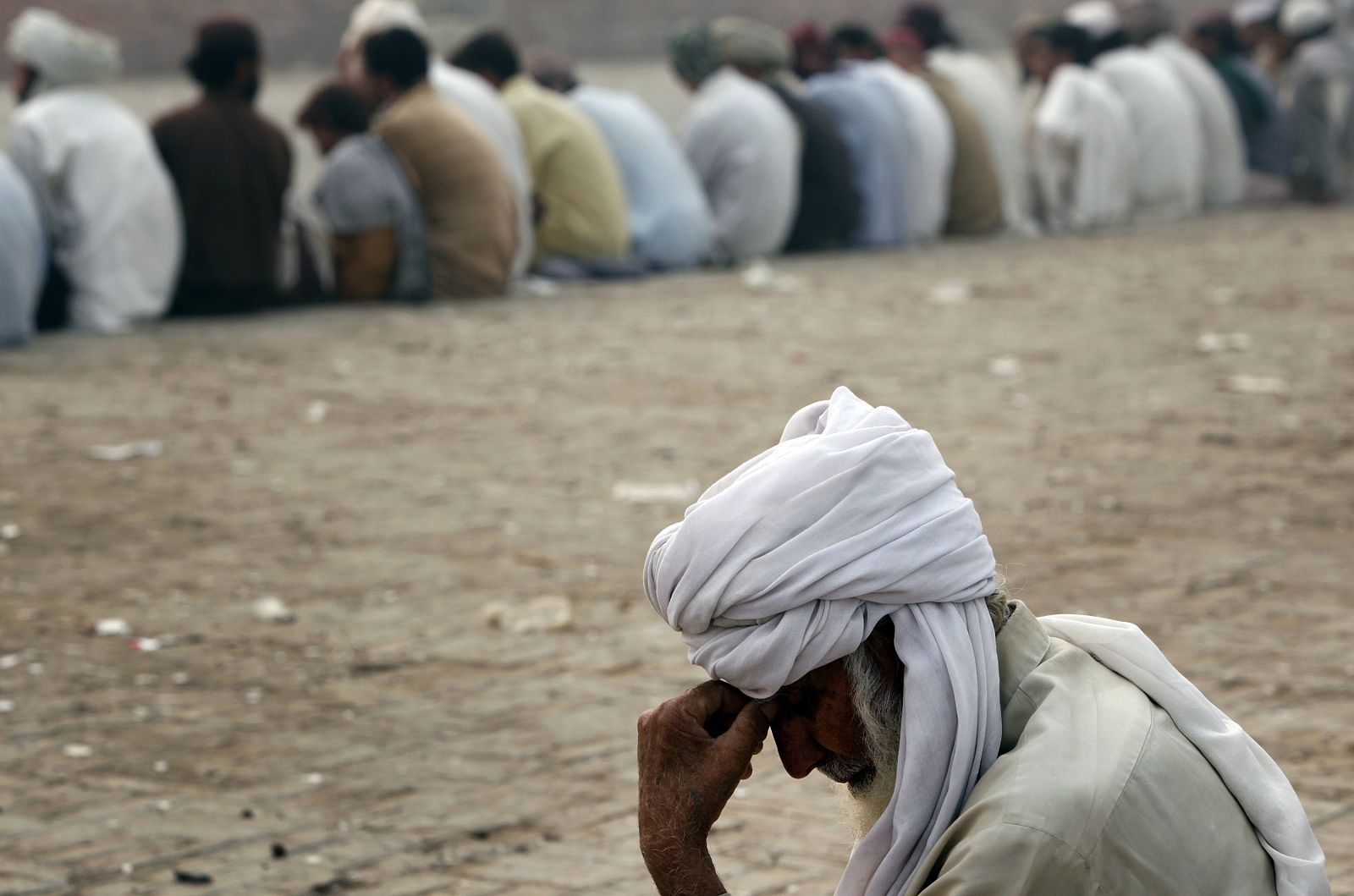 A man fleeing a military offensive in South Waziristan, waits for his turn to receive handouts with others at a food distribution point for IDP in Dera Ismail Khan