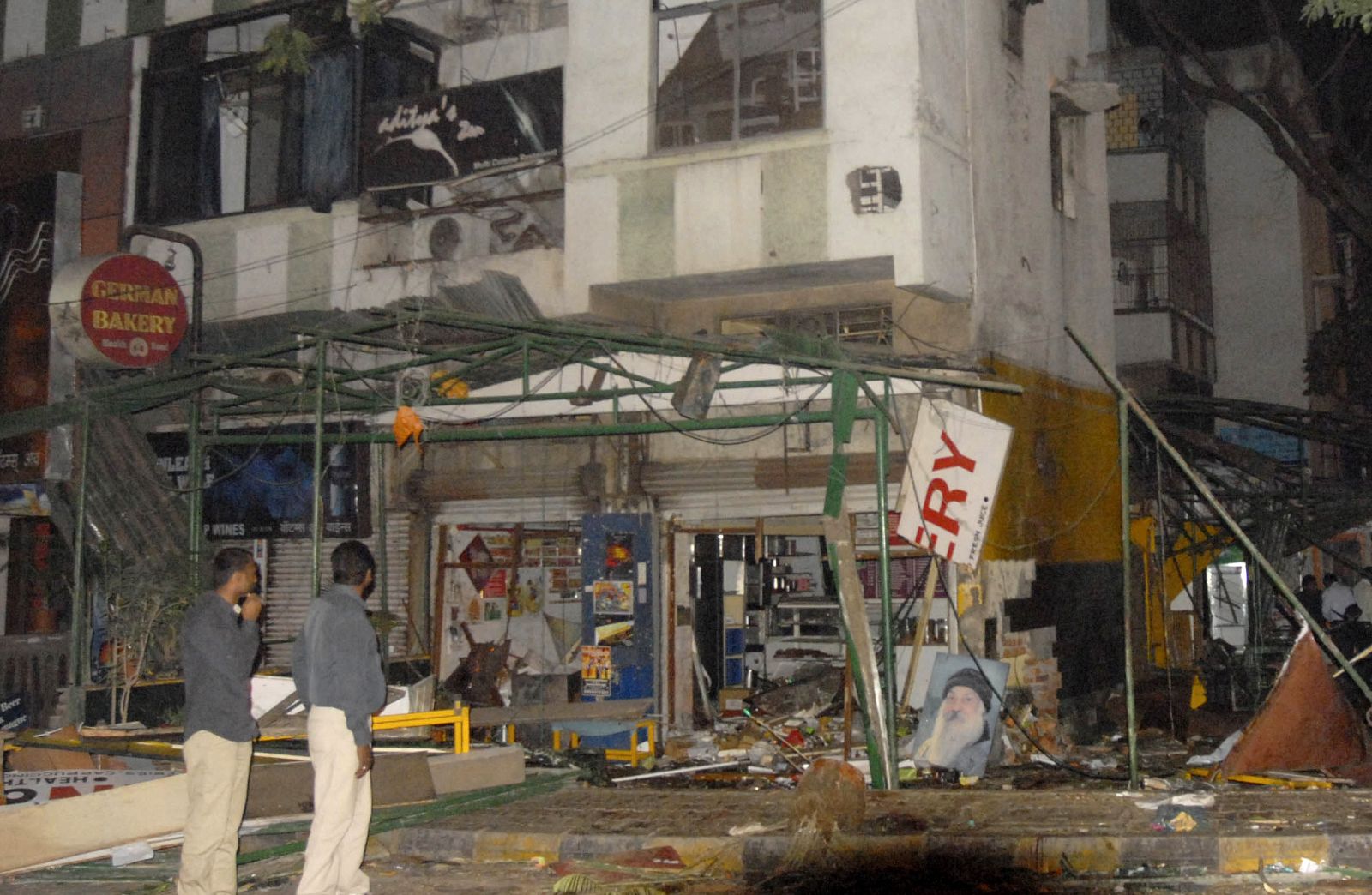 Police gather at the site of a bomb blast in Pune