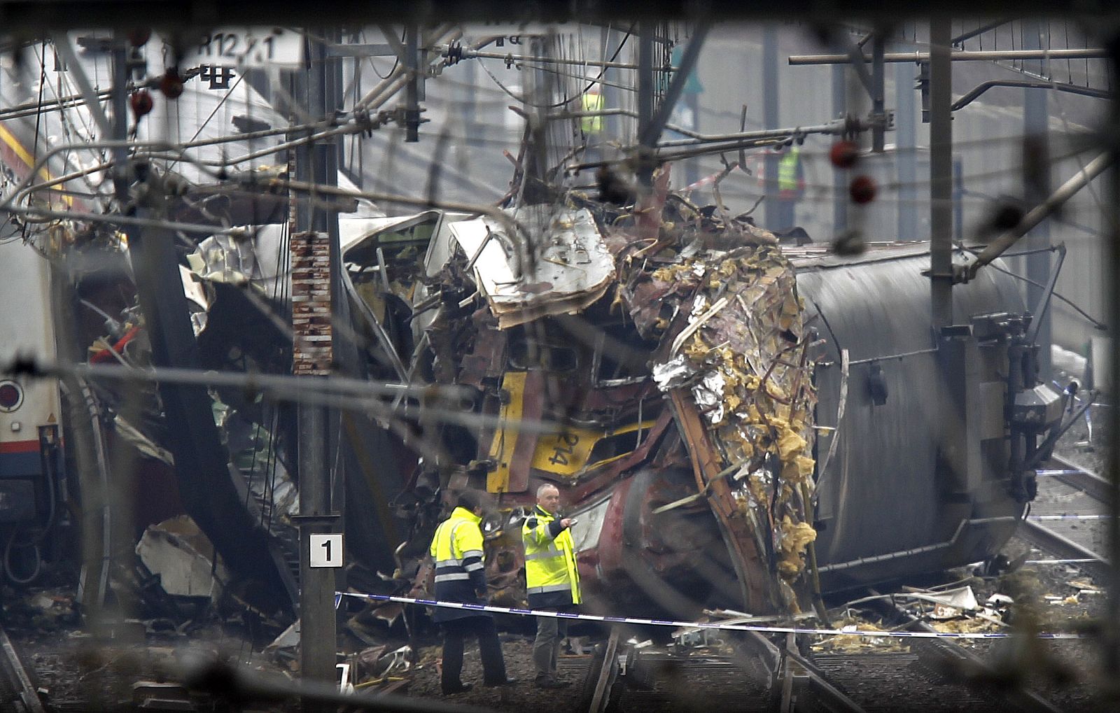 Experts at Belgian railway company SNCB-NMBS look at wreckage of train in Buizingen
