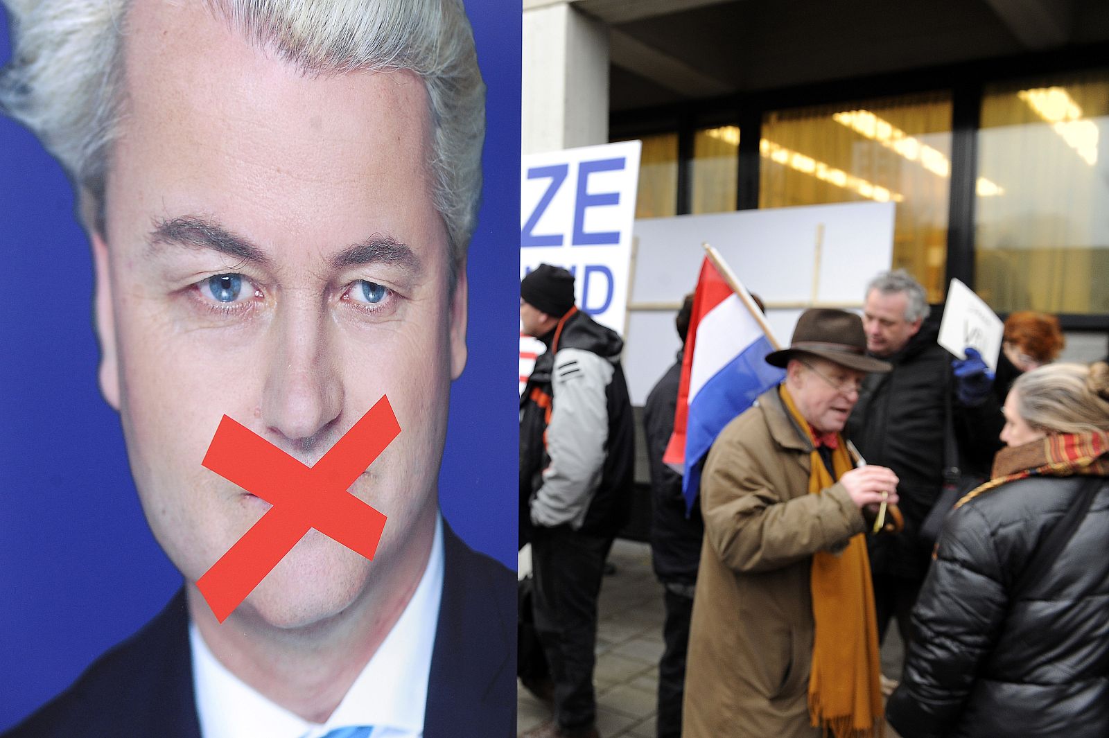 Crowd of protesters gather behind police barriers to voice support for right-wing Dutch MP Geert Wilders outside the court in Amsterdam
