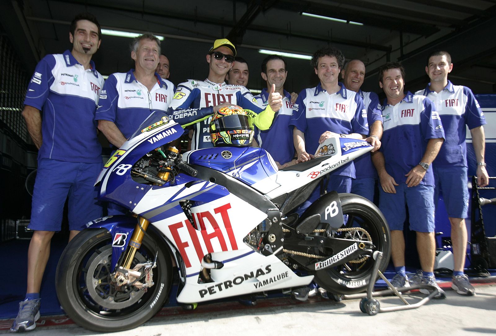 Yamaha MotoGP rider Rossi of Italy poses with his team during the unveiling of his machine at Sepang circuit outside Kuala Lumpur