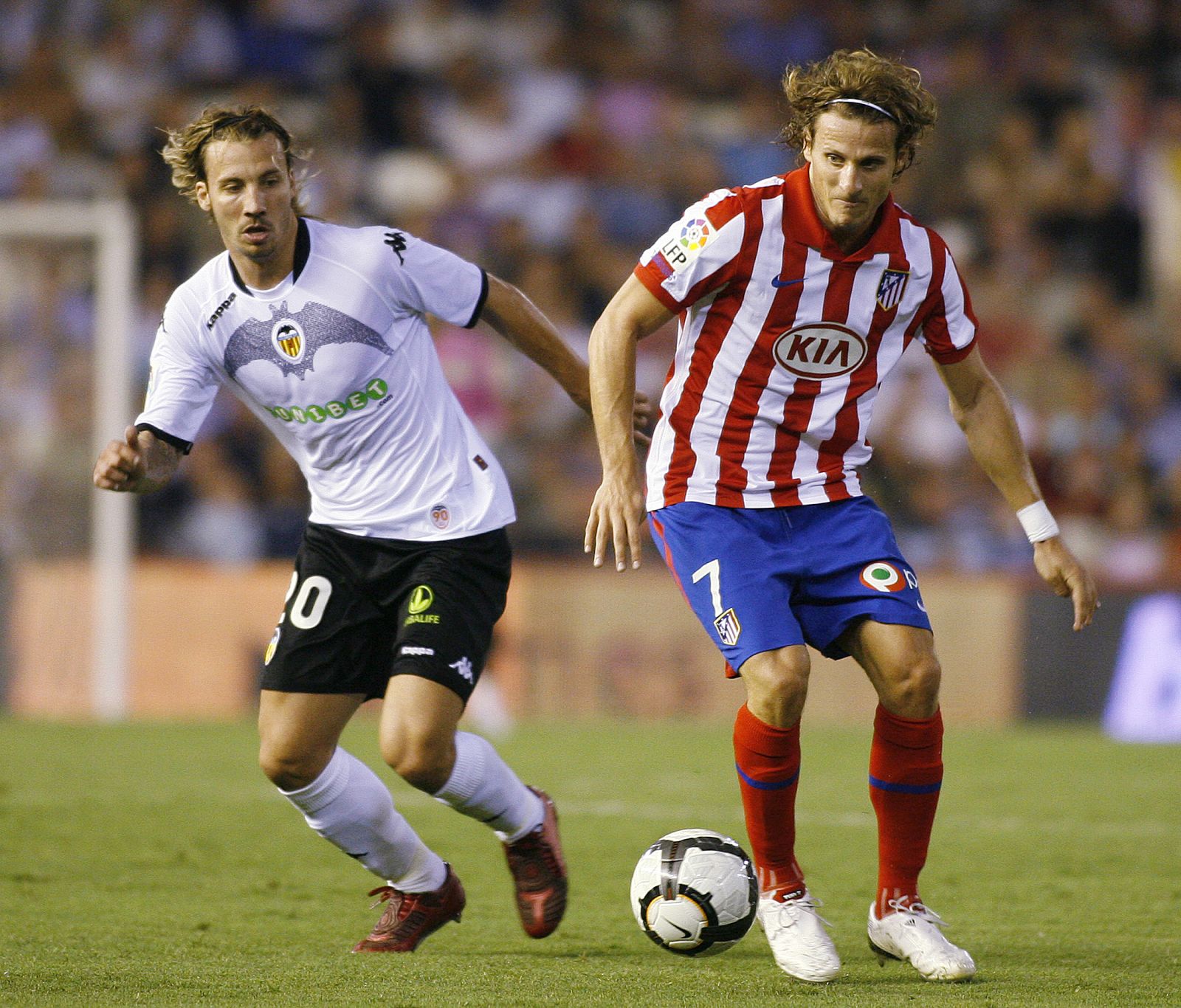 Atletico Madrid's Forlan and Valencia's Alexis fight for the ball during their Spanish first division soccer match in Valencia