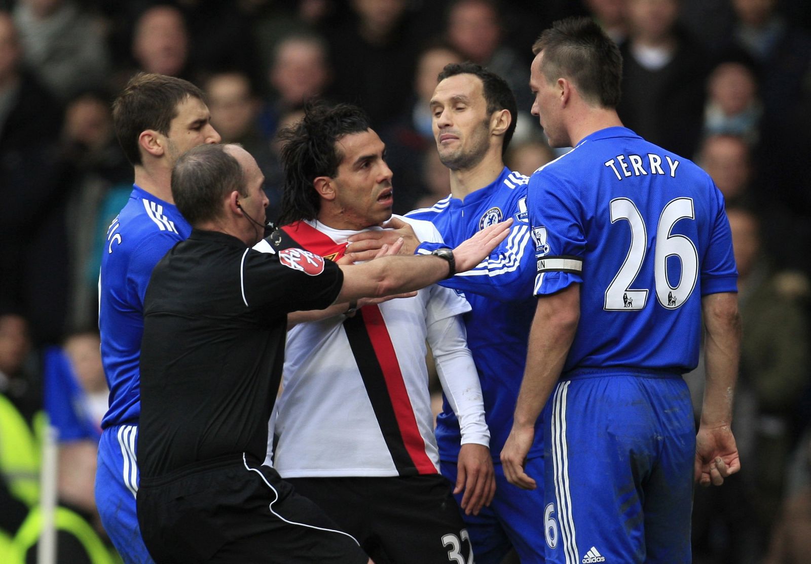 Chelsea's John Terry fronts up to Manchester City's Carlos Tevez after fouling him in London