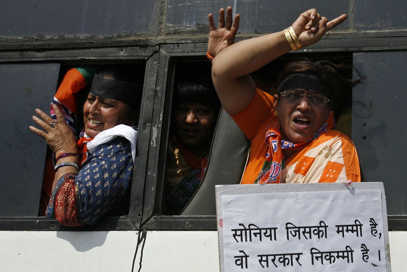 Women activists of BJP shout slogans after being detained by police during a protest against the ruling government for women's reservation bill in New Delhi