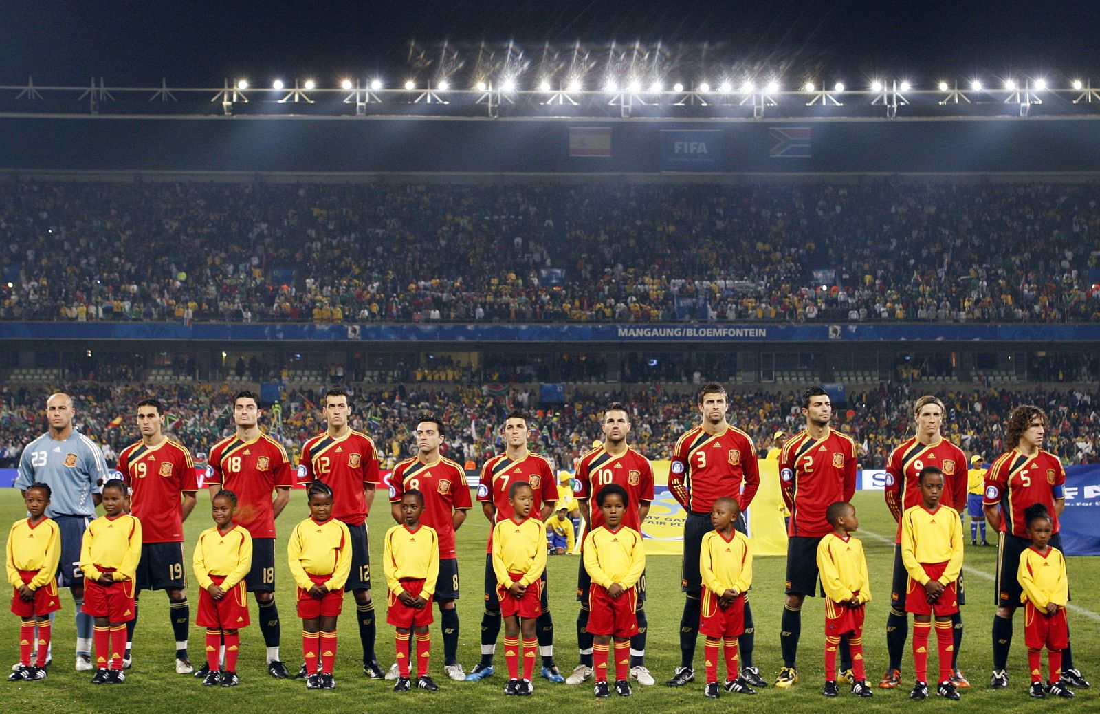 Members of Spain's national soccer team listen to their national anthem before the start of their Confederations Cup soccer match against South Africa at the Free State Stadium in Bloemfontein