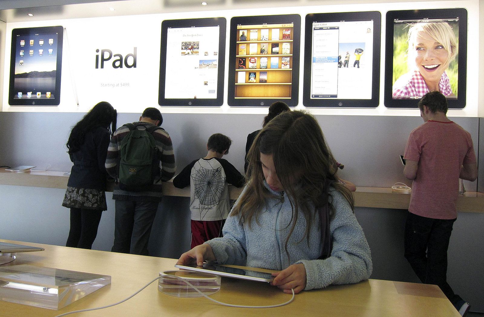 Customers look at the new iPad during Apple's iPad launch at a store in New York