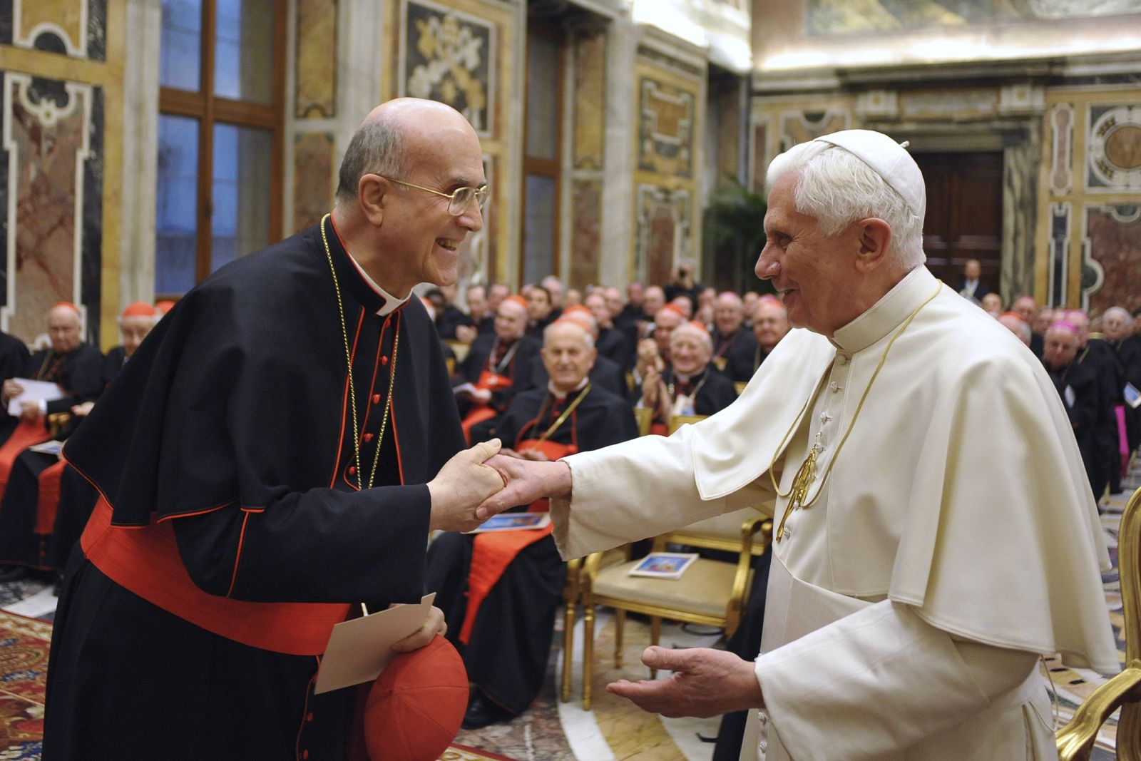 Pope Benedict XVI is greeted by Vatican State minister Cardinal Tarcisio Bertone before a concert on the occasion of his name day at the Vatican