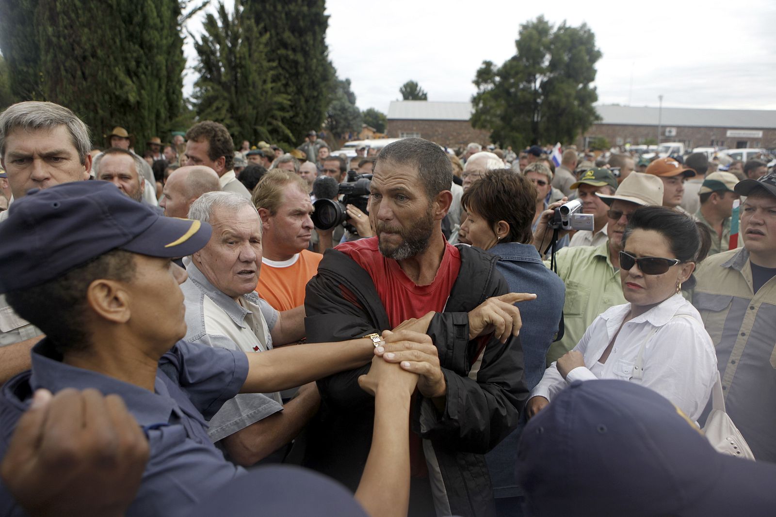 Supporter of the AWB is restrained by police outside a South African court in Ventersdorp, in the North West Province