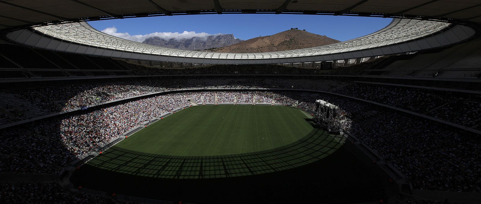 Cape Town's backdrop Table Mountain peaks through crowds during a religious event to test the capacity of the city's 2010 Fifa Soccer World Cup stadium