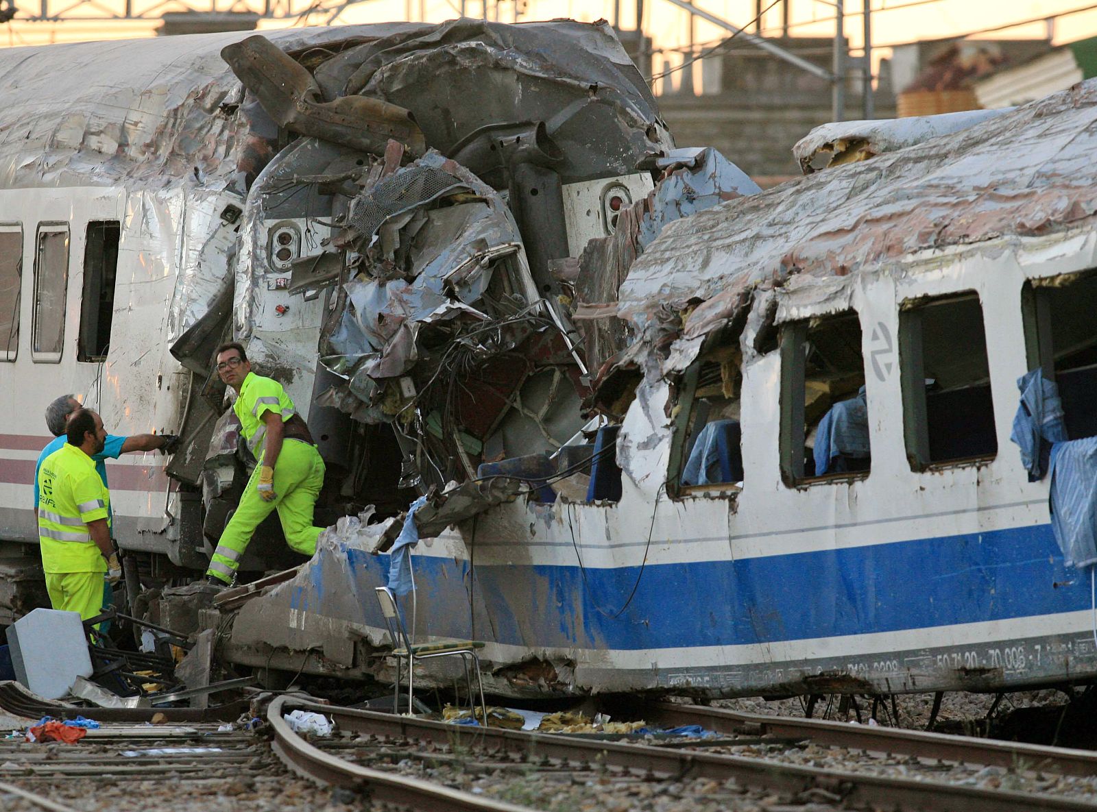 Rescue workers and officials stand near site of a train crash in Villada