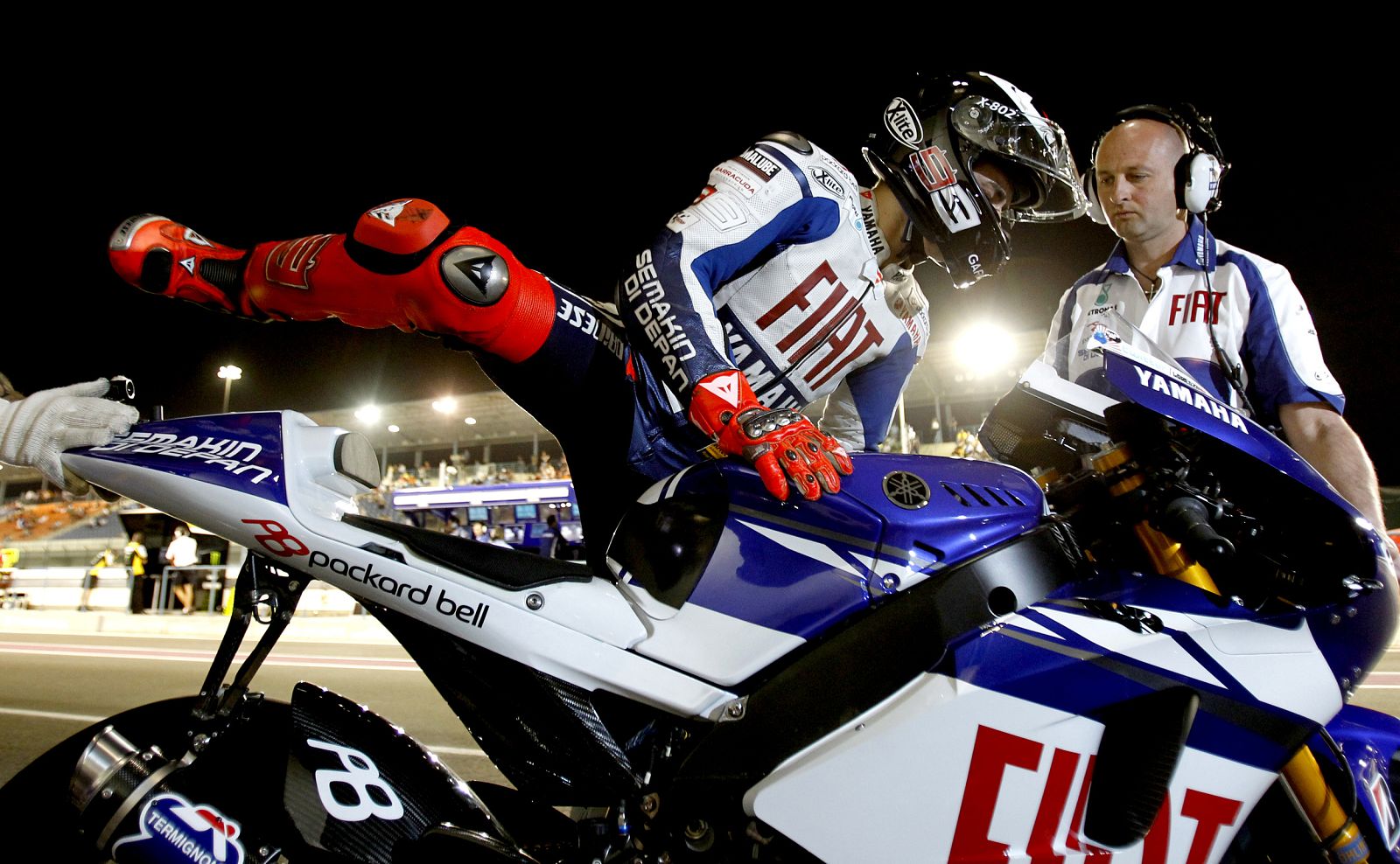Yamaha MotoGP rider Lorenzo of Spain gets onto his motorcycle before a race at the MotoGP World Championship in Doha