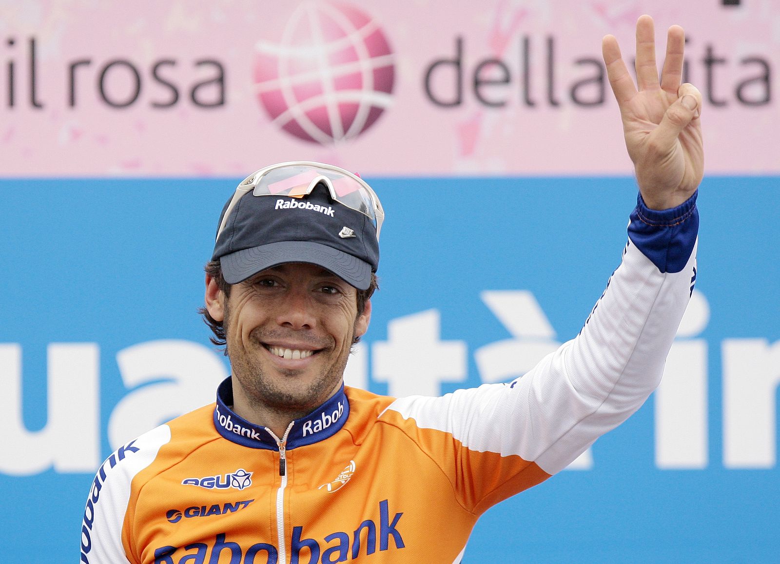 Freire celebrates on the podium after winning the Classic road race for the third time in San Remo