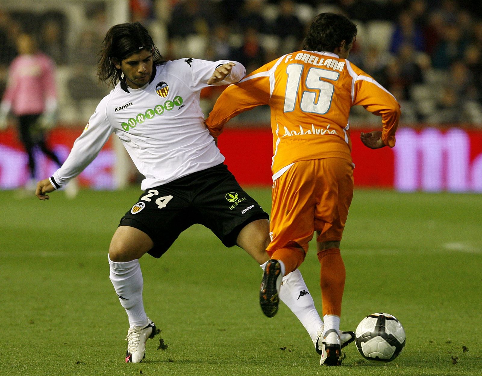 Valencia's Banega and Xerez's Orellana fight for the ball during their Spanish first division soccer match in Valencia