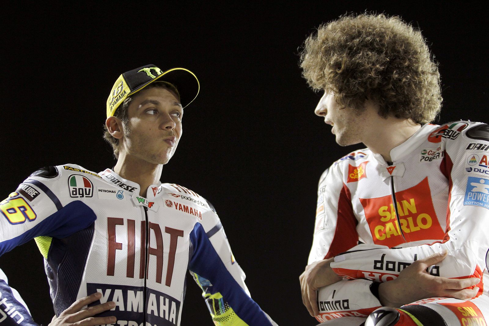 Fiat Yamaha MotoGP rider Rossi talks with San Carlo Honda Gresini rider Simoncelli before start of free practice session of MotoGP World Championship at Losail International circuit in Doha