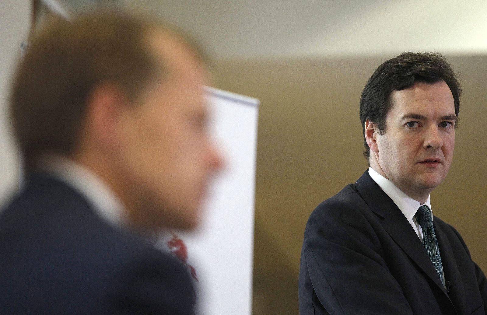 Britain's Chancellor of the Exchequer  Osborne looks over at Treasury Secretary Laws during a press conference at the Treasury, in central London