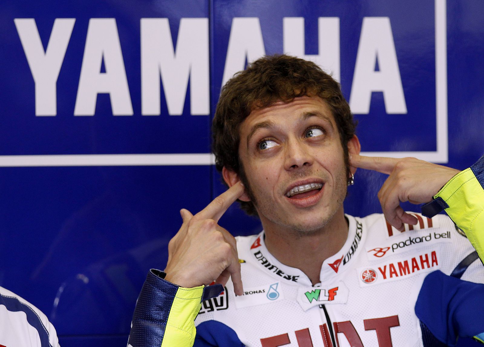Yamaha MotoGP rider Valentino Rossi of Italy puts on earplugs during the first free practice session of the Spanish Grand Prix in Jerez