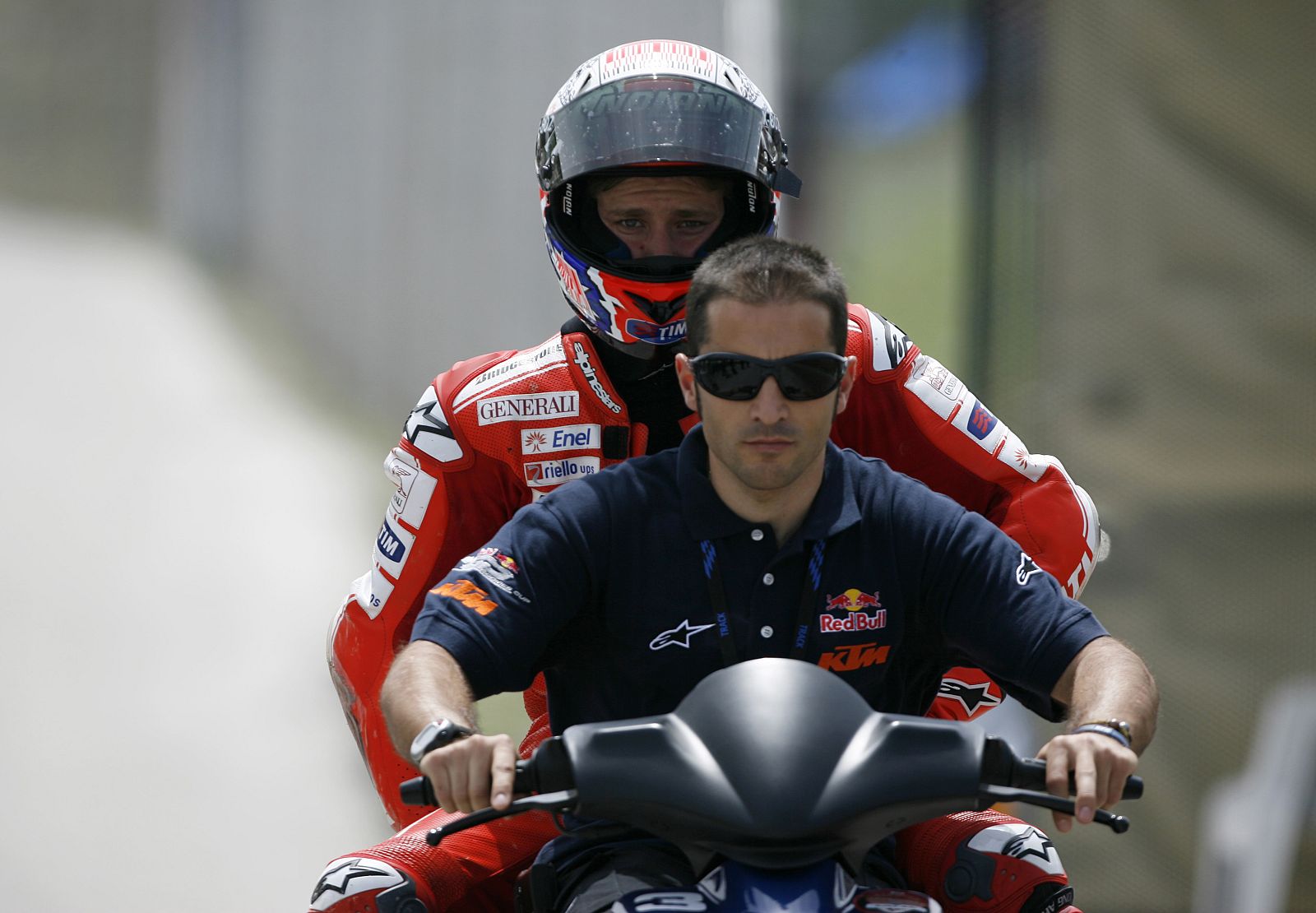 Ducati MotoGP rider Stoner of Australia is taken to the pits after falling from his bike during the Spanish Grand Prix in Jerez