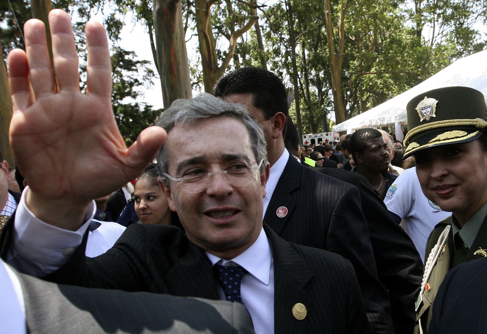 Colombia's President Alvaro Uribe waves after attending the inauguration ceremony of Costa Rica's President Laura Chinchilla in San Jose