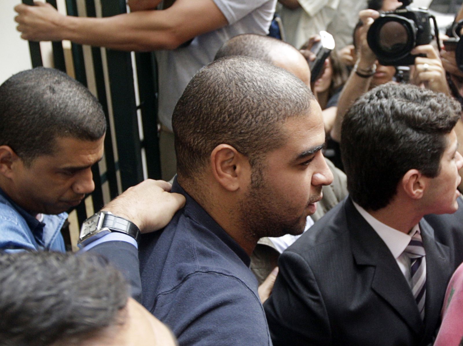 Brazilian soccer striker Adriano leaves the district attorney's office after being summoned to speak to a judge about photographs published in the local press of him holding an alleged rifle, in Rio de Janeiro