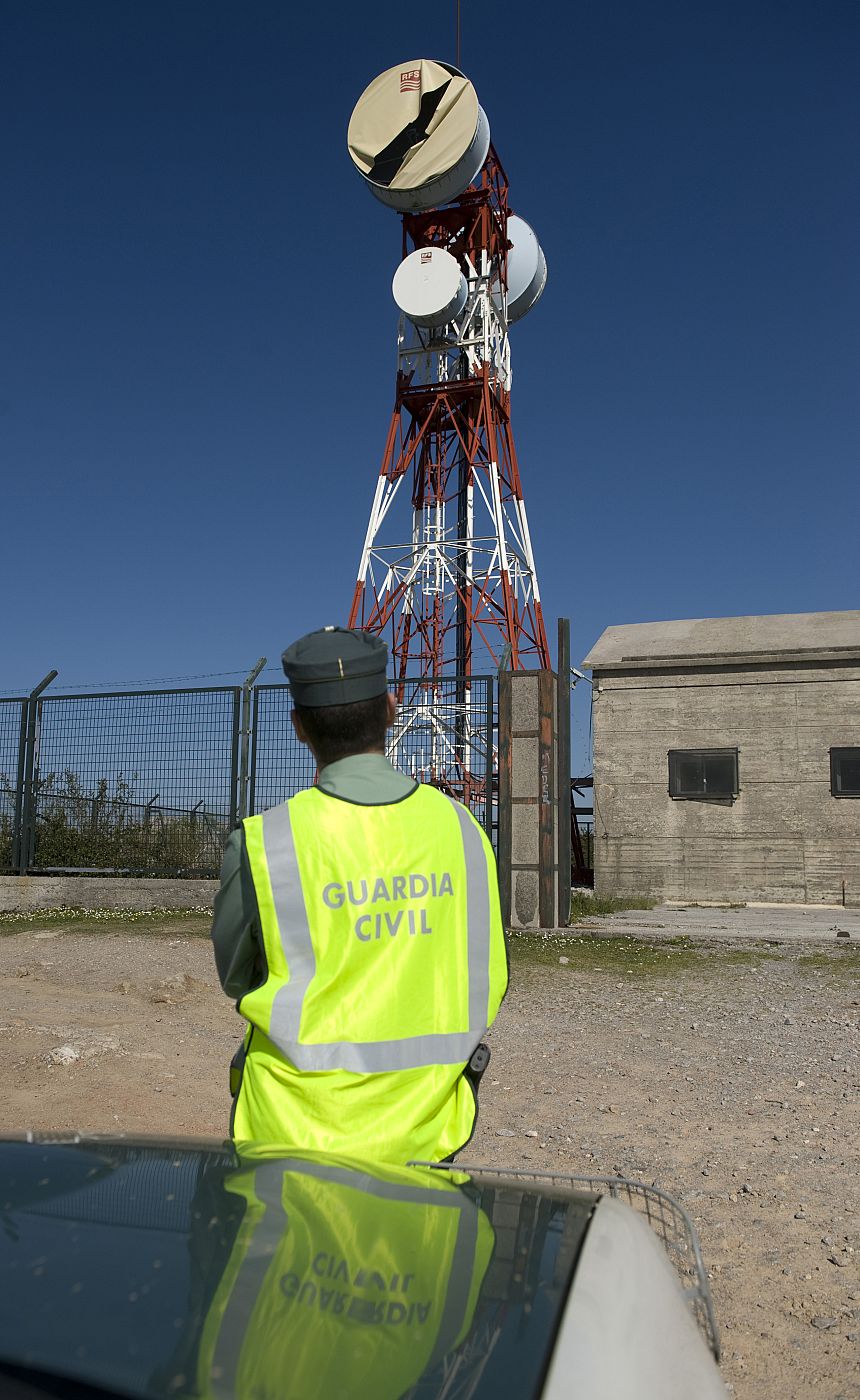 A Spanish Civil Guard guards a telephone antenna station after a bomb attack in the mountain pass of La Granja