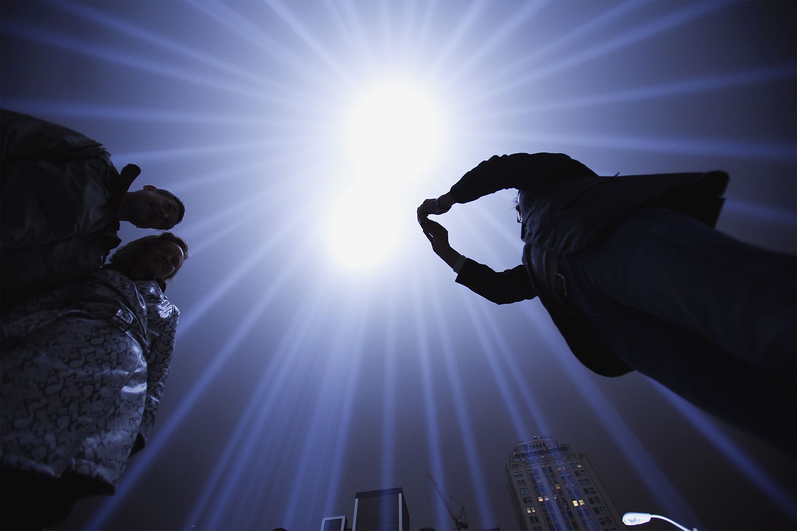 Gustavo Bonevardi takes a photograph of Laurie Ogle and Patrick Stretch inside of the "Tribute in Lights" in Manhattan on the eighth anniversary of the attack on the World Trade Center in New York