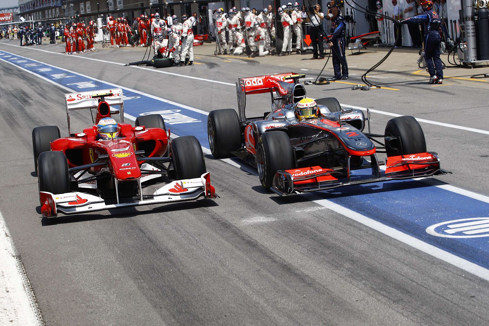 Ferrari Formula One driver Alonso and McLaren Formula One driver Hamilton leave the pits during the Canadian F1 Grand Prix in Montreal