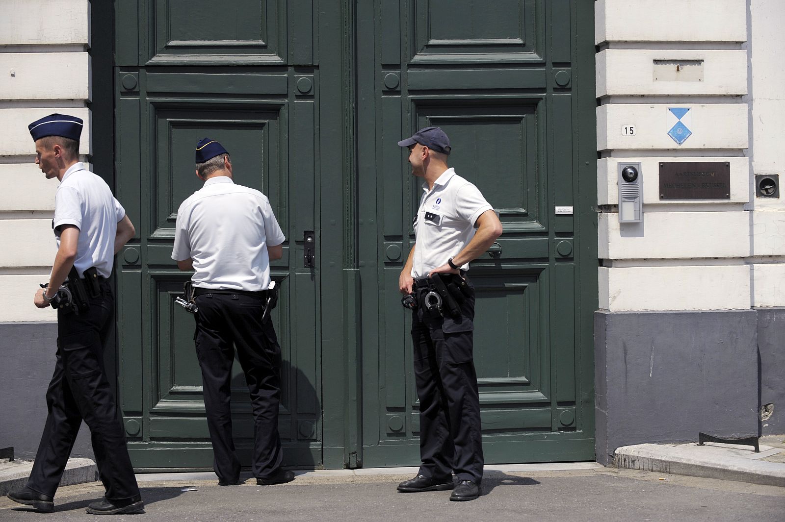 Police officers stand outside the office of the Archbishop of Mechelen-Brussels in Mechelen