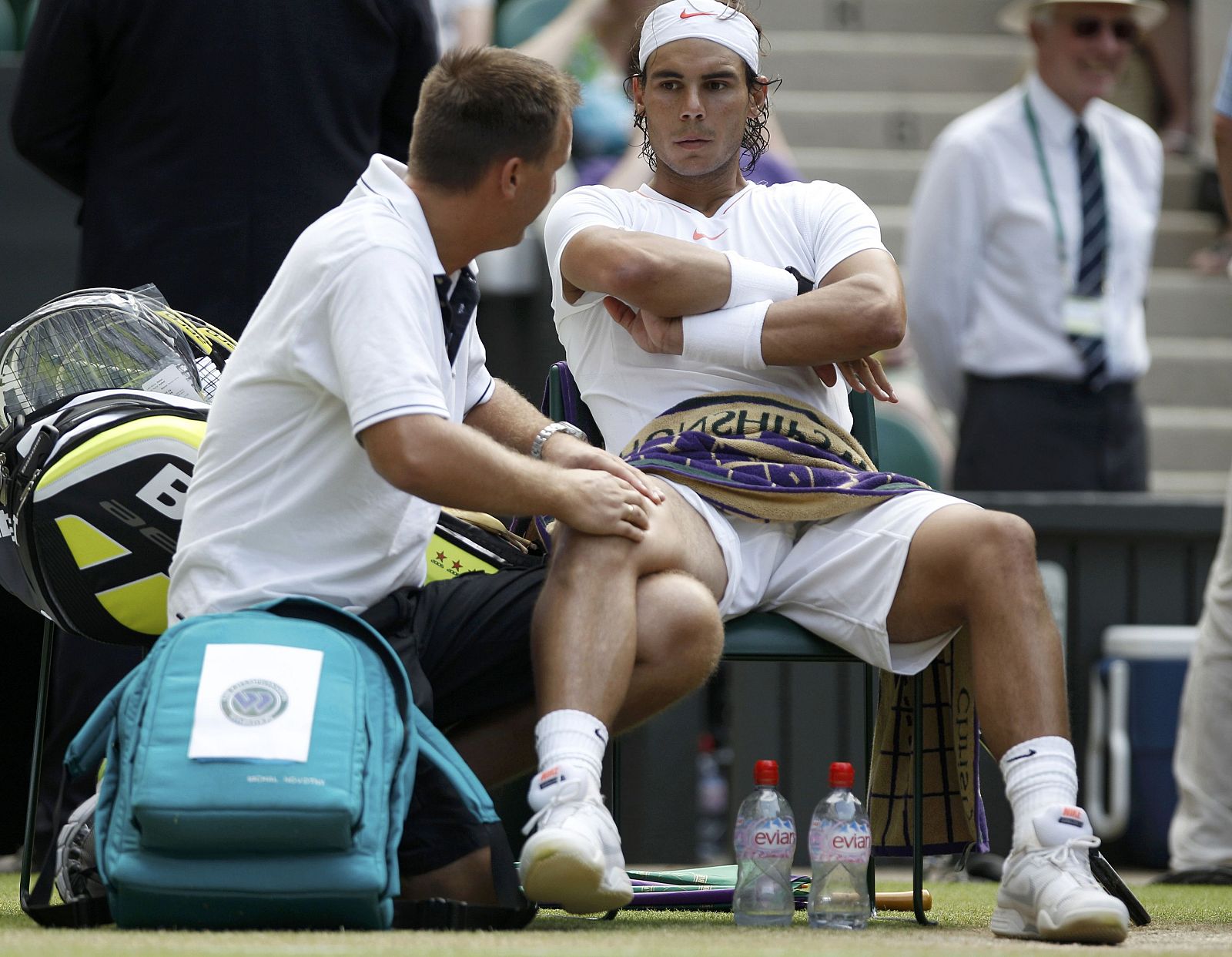 A trainer works on the leg of Spain's Rafael Nadal in his match against Germany's Philipp Petzschner at the 2010 Wimbledon tennis championships in London