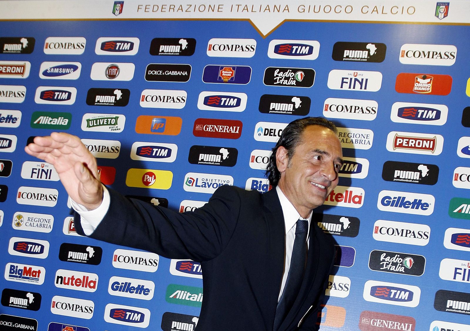 Newly appointed Italian national soccer team coach Prandelli waves after a news conference in Rome