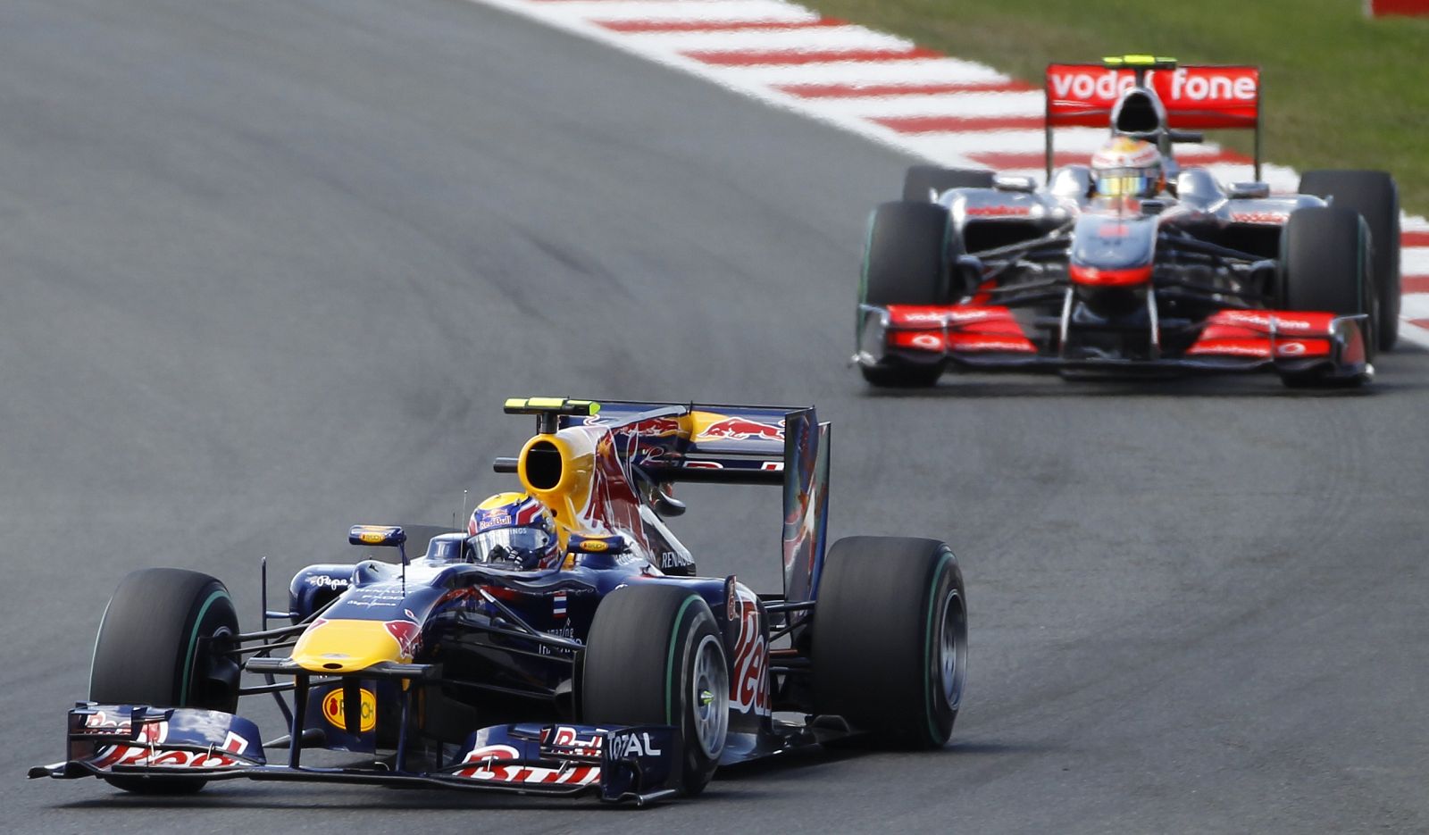 Red Bull Formula One driver Mark Webber of Australia leads McLaren's Lewis Hamilton of Britain at the start of the British F1 Grand Prix at Silverstone