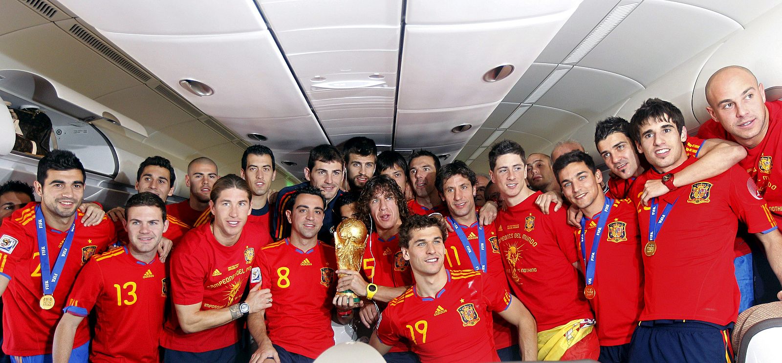 Los jugadores de la selección española de fútbol posan con la Copa del Mundo, en el avión de regreso de Johannesburgo