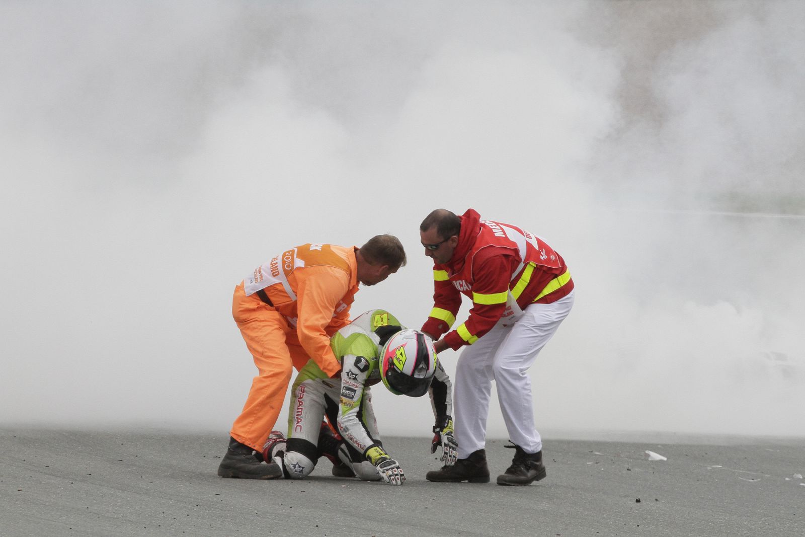 Medics help Ducati MotoGP rider Espargaro of Spain after a crash during German Grand Prix at Sachsenring circuit