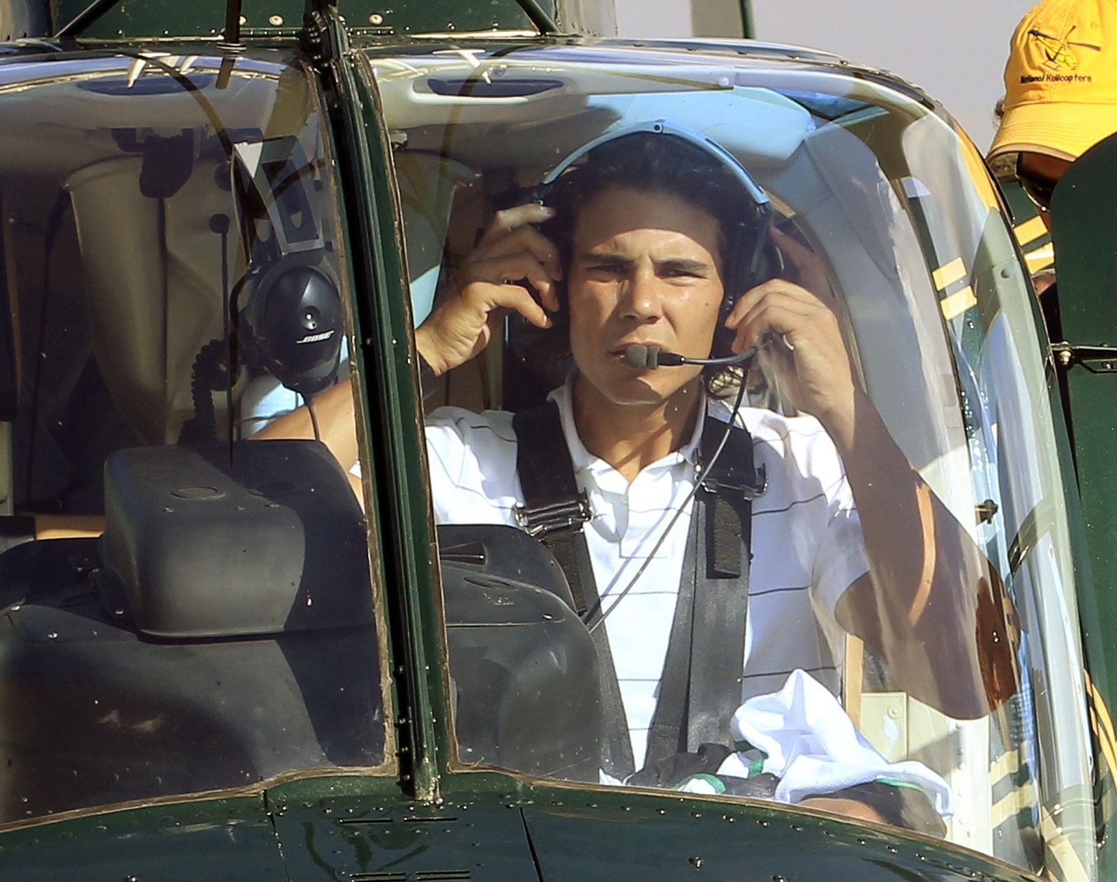 Rafael Nadal adjusts his head set before being flown by helicopter to practice for the Rogers Cup tennis tournament in Toronto