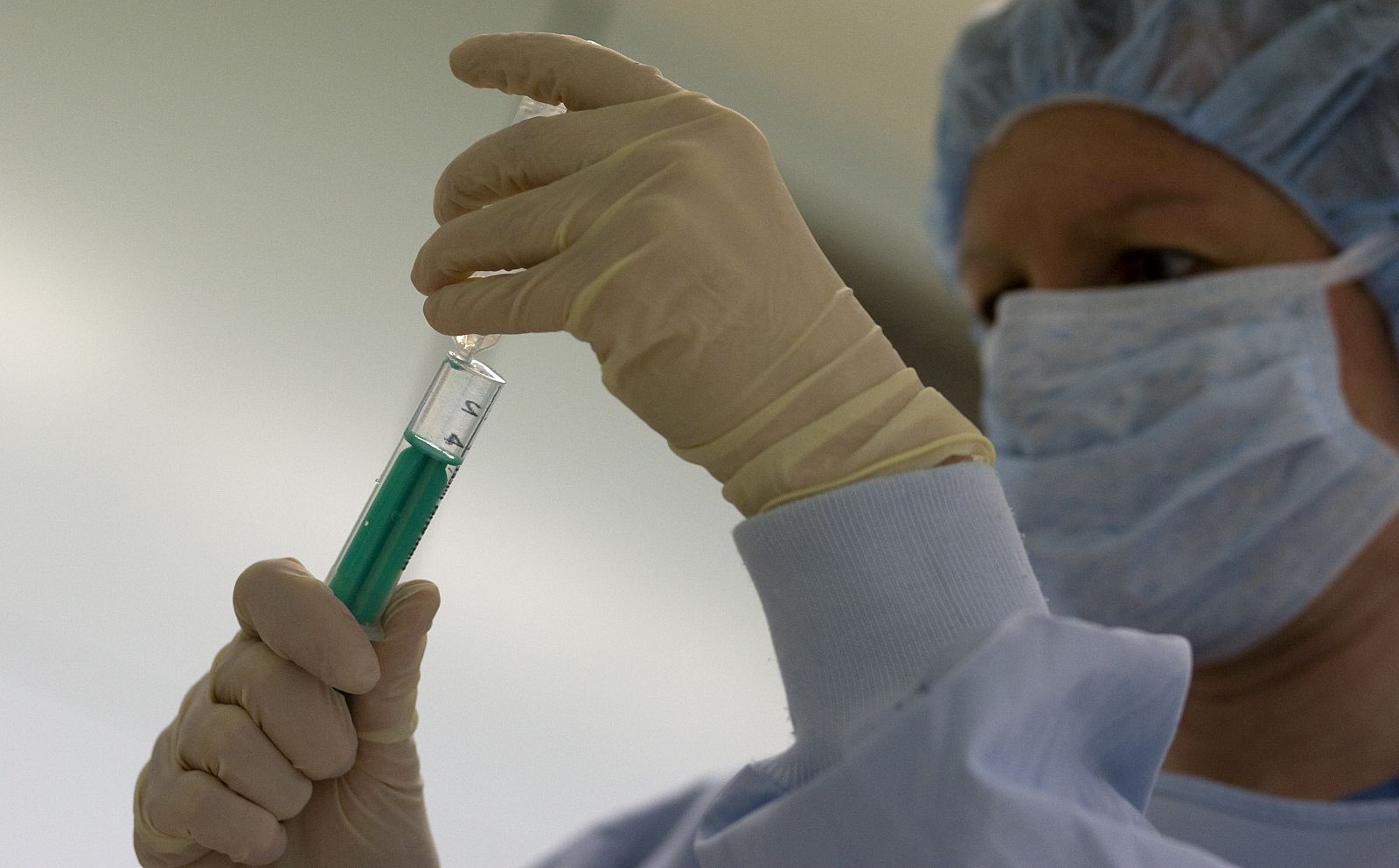 A surgery nurse washes her hands before starting procedures to clean the wound of an amputee patient with MRSA at Unfallkrankenhaus Berlin hospital