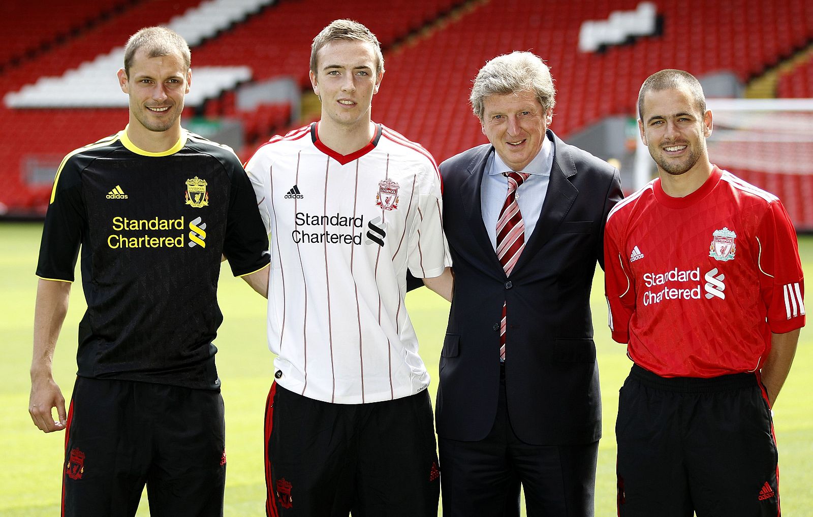 Liverpool manager Roy Hodgson poses for photographers with new signings Joe Cole, Danny Wilson and Milan Jovanovic following a news conference at the club's Anfield stadium in Liverpool