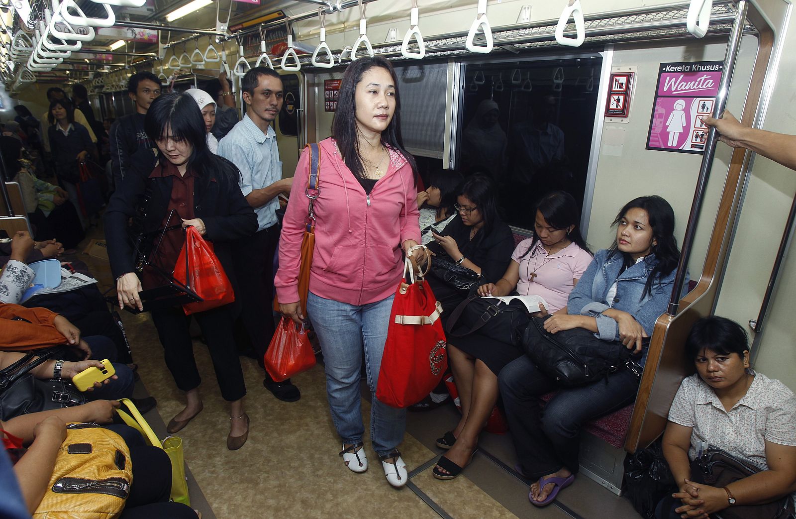 Women board a women-only train carriage in Jakarta