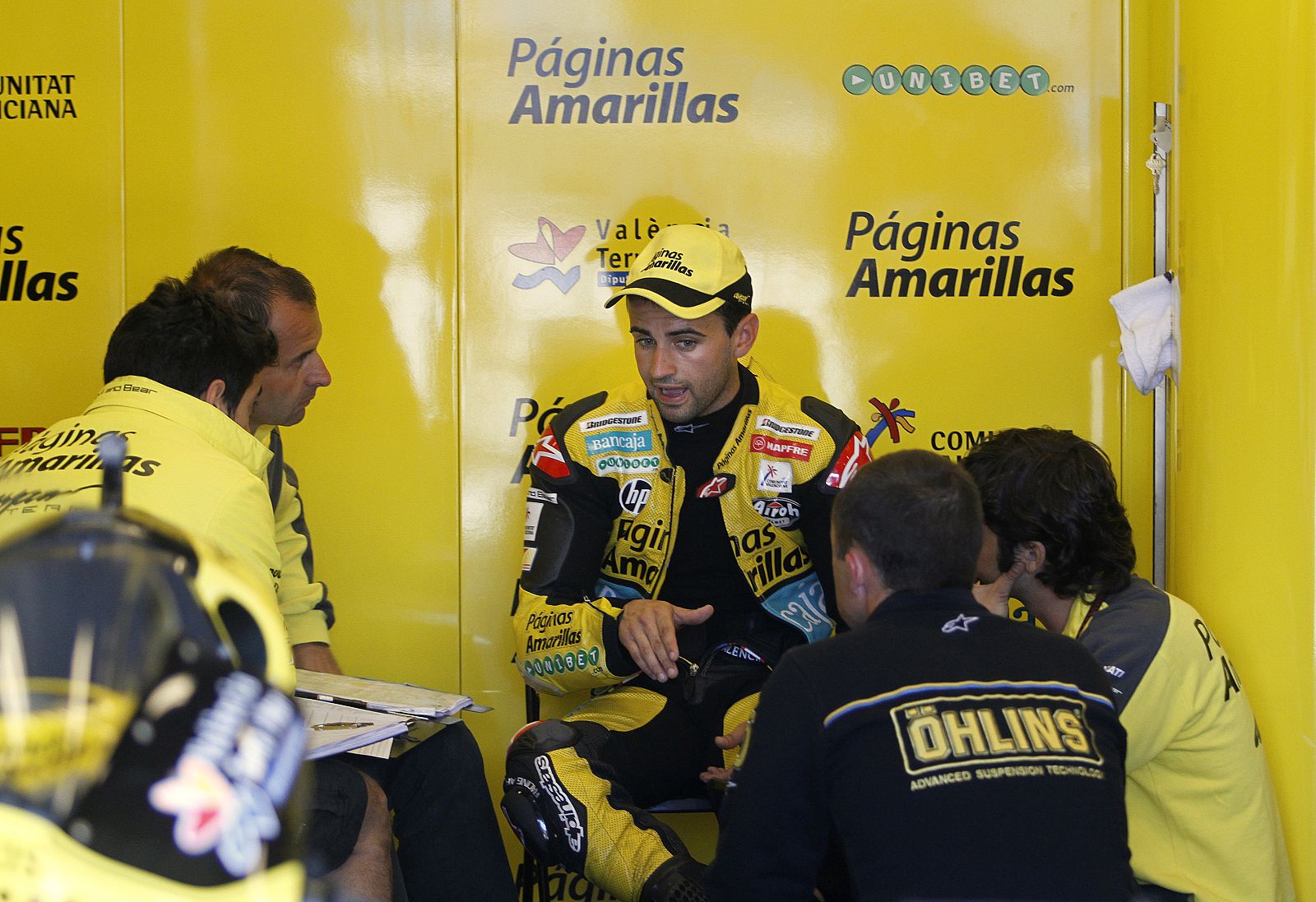 Ducati MotoGP rider Hector Barbera of Spain speaks with his pit crew after the first practice round of the U.S. Grand Prix at Laguna Seca Raceway in Monterey