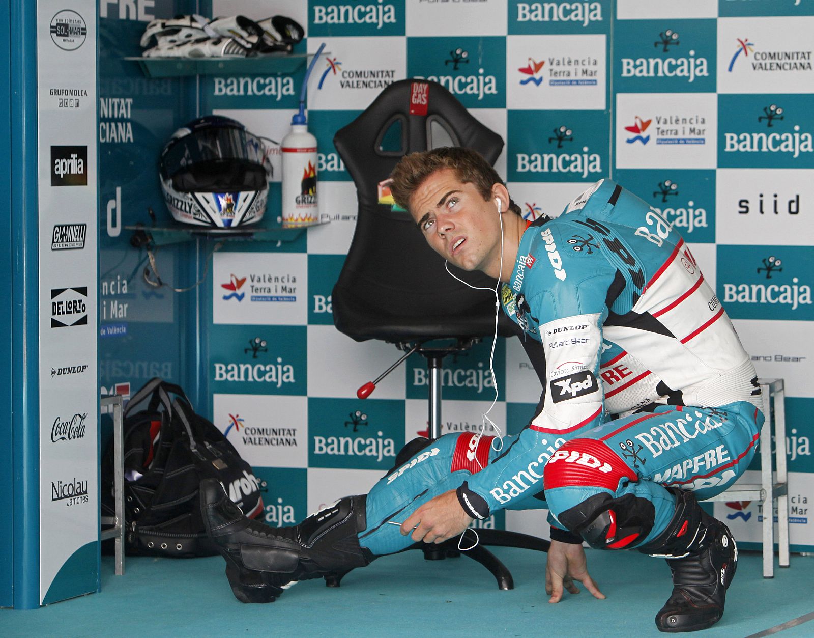 Aprilia 125 cc rider Terol stretches during the free practice session of the Czech Grand Prix in Brno