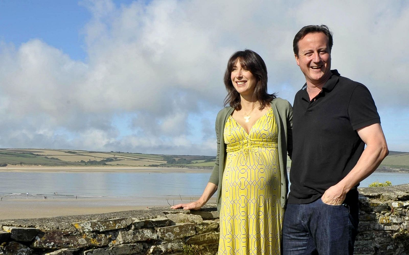 Britain's Prime Minister David Cameron, and his wife Samantha, pose for a photograph on the coastal path at Daymer Bay in Cornwall