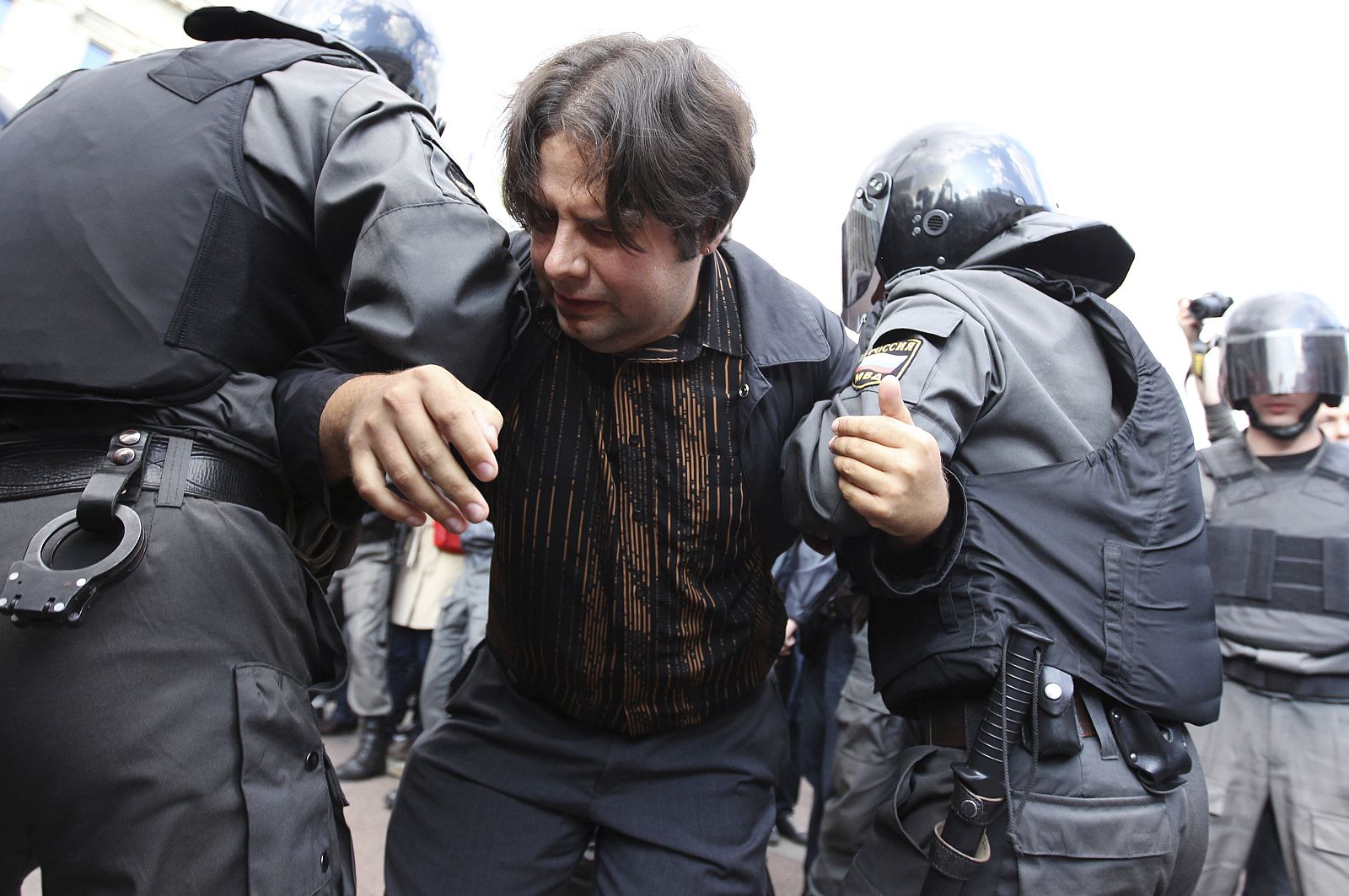 Policemen detain an opposition party supporter during an unauthorised protest rally to defend Article 31 of the Constitution of the Russian Federation in St. Petersburg
