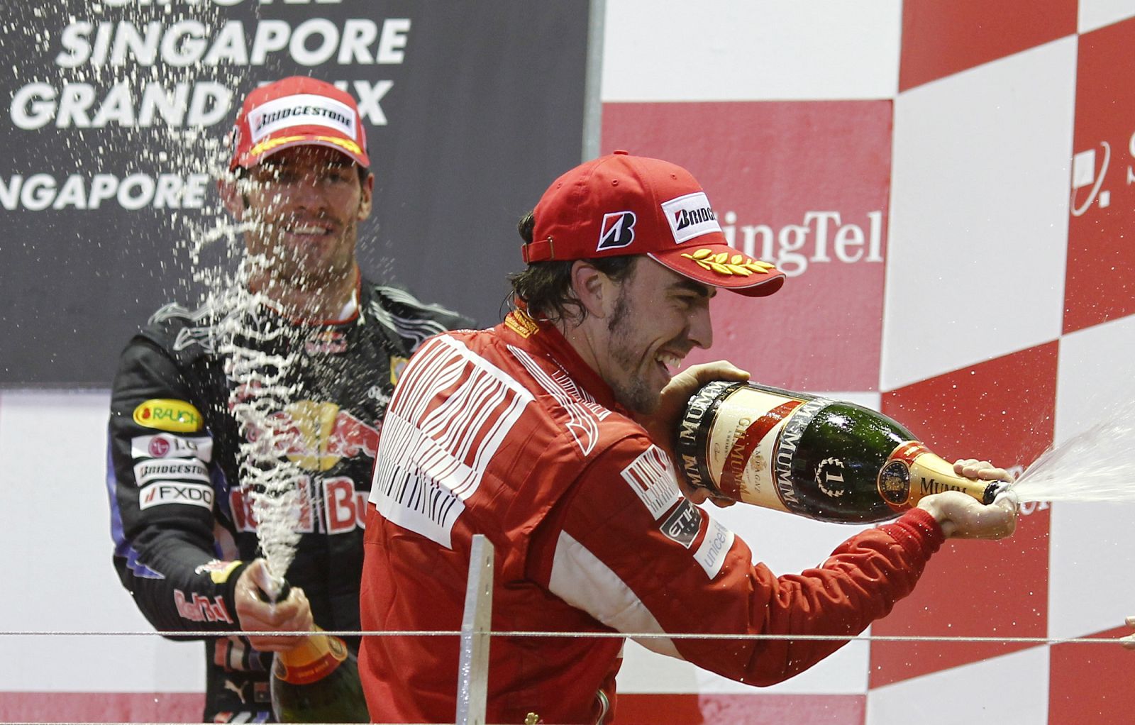 Ferrari Formula One driver Fernando Alonso of Spain celebrates on the podium after winning the Singapore F1 Grand Prix at the Marina Bay circuit