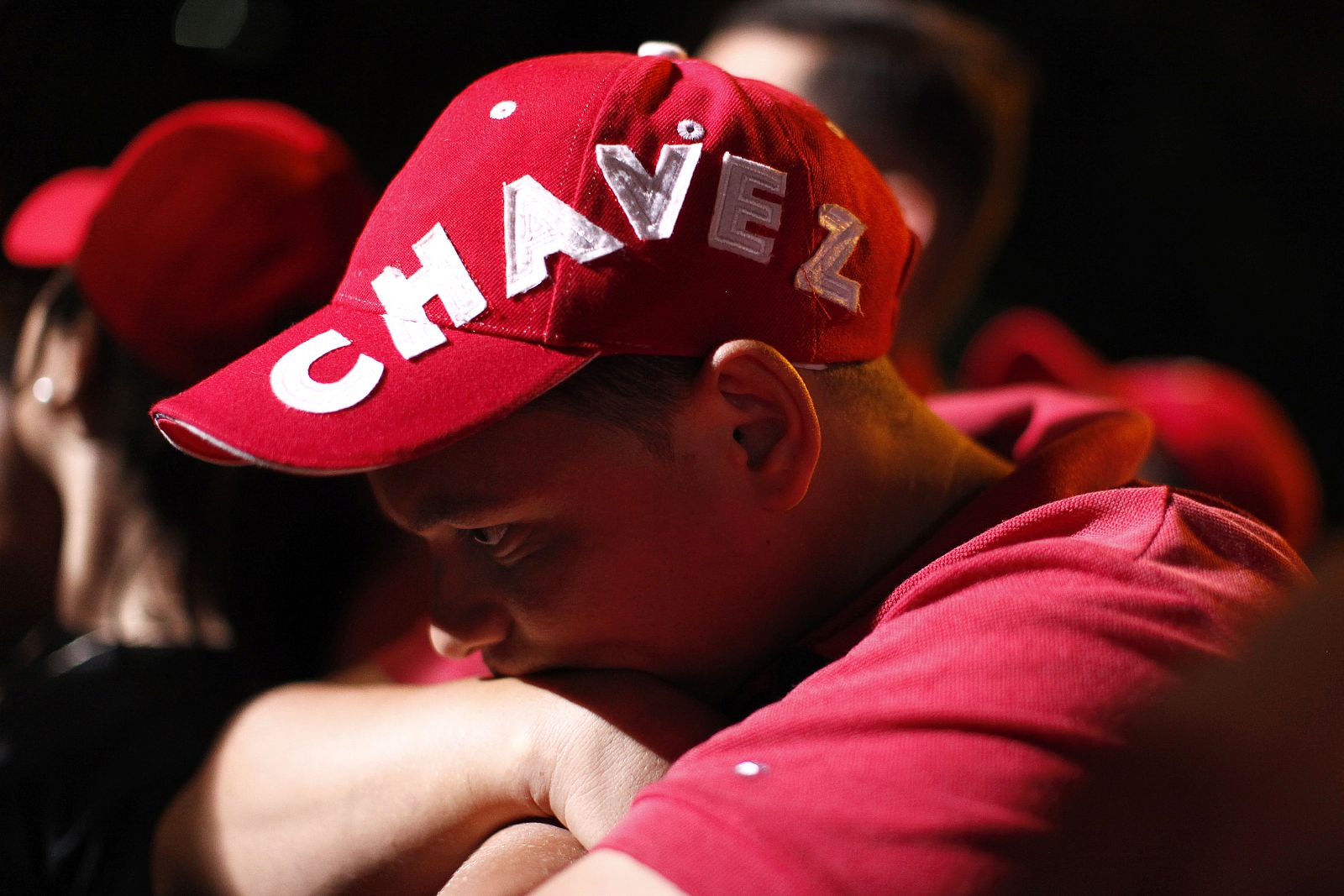 A supporter of Venezuelan President Hugo Chavez reacts while listening to parliamentary elections results outside Miraflores Palace in Caracas